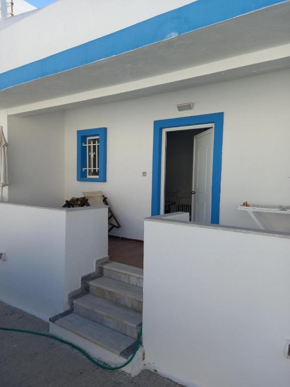 a room with stairs and a blue and white wall at Apartment PAPAS in Mastihari