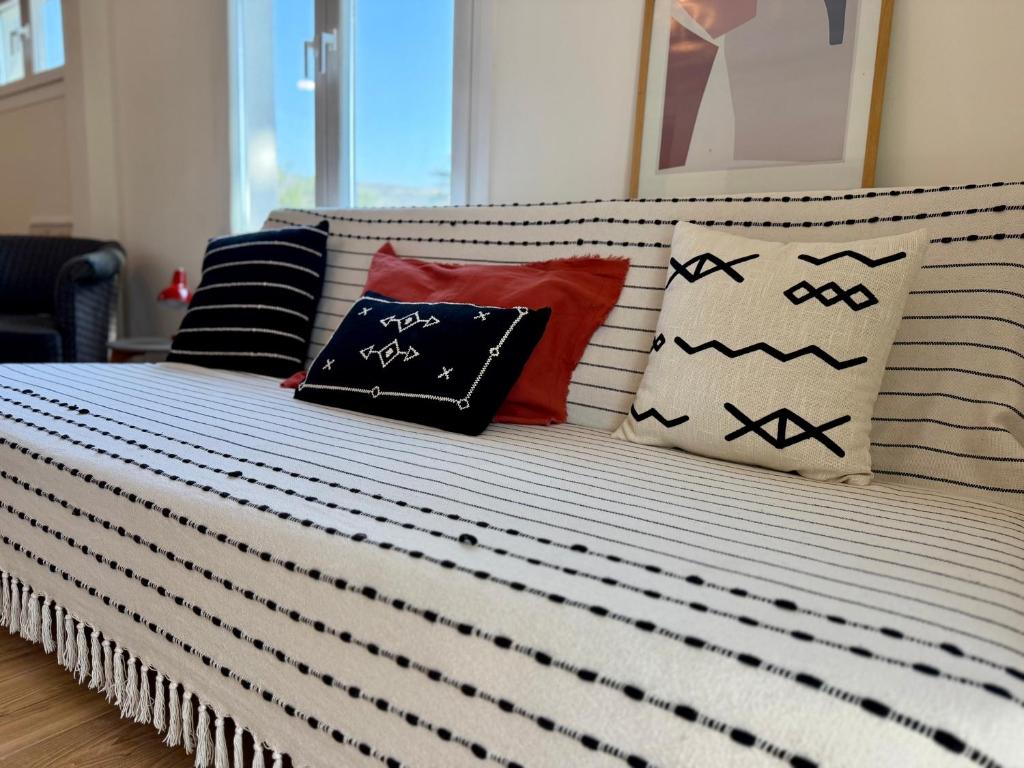 a bed with several pillows on top of it at Themis in Aghia Marina
