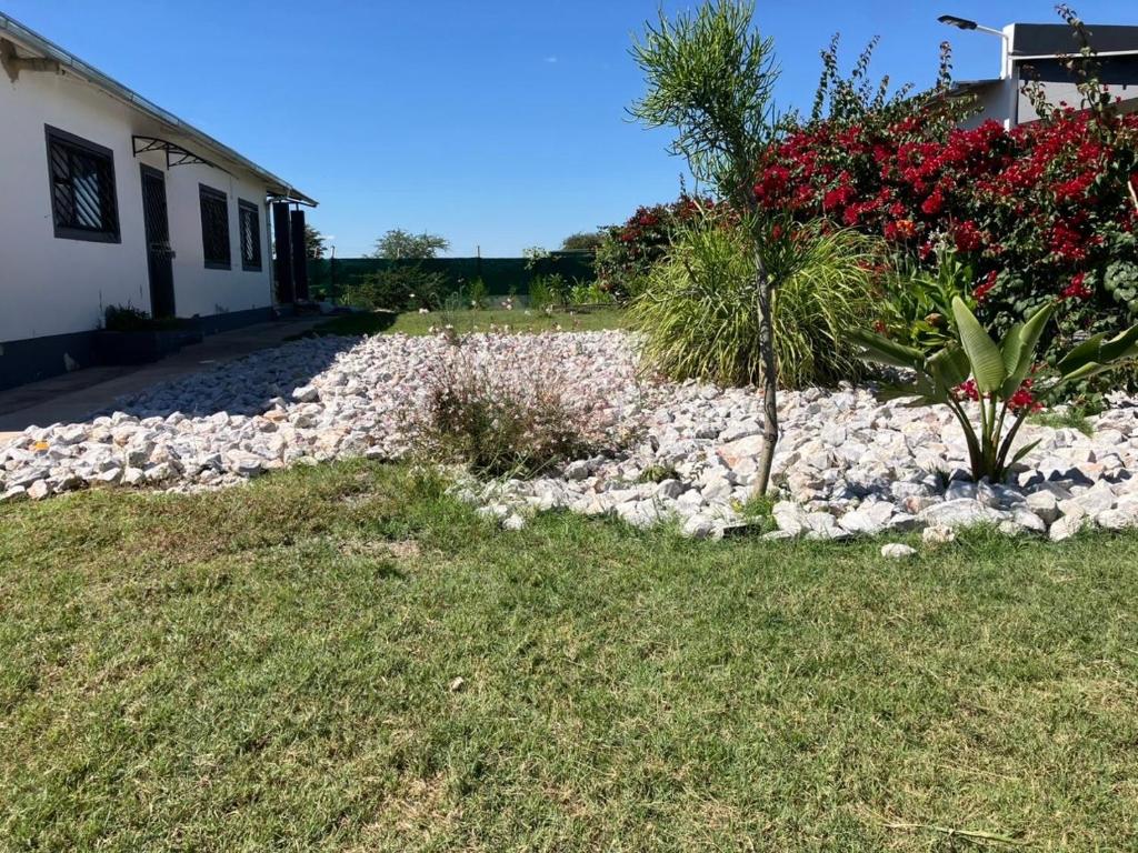 a rock garden in front of a house at F2 Homestead in Omuthiya