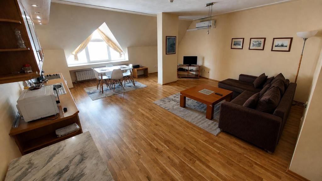 a living room with a couch and a table at апартамент Хармония in Gotse Delchev