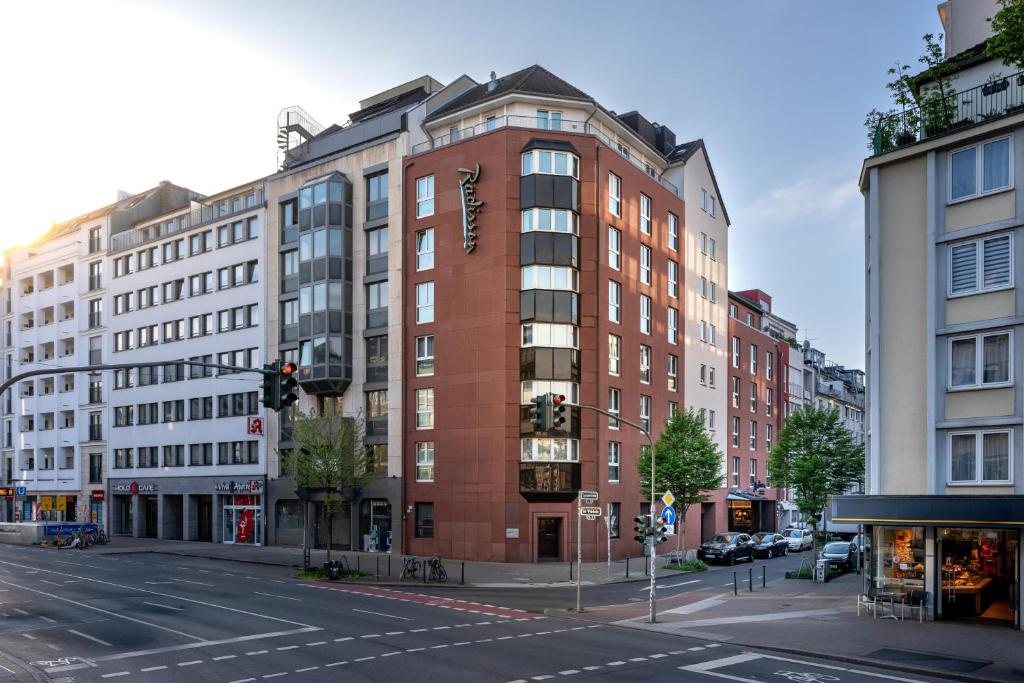 a tall red brick building on a city street at Radisson Hotel Düsseldorf City Center in Düsseldorf