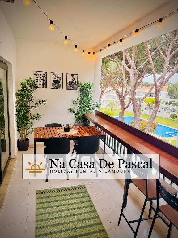 a dining room with a table and chairs and a pool at Vilamoura 2 Bedroom with Pool - Na Casa De Pascal in Vilamoura