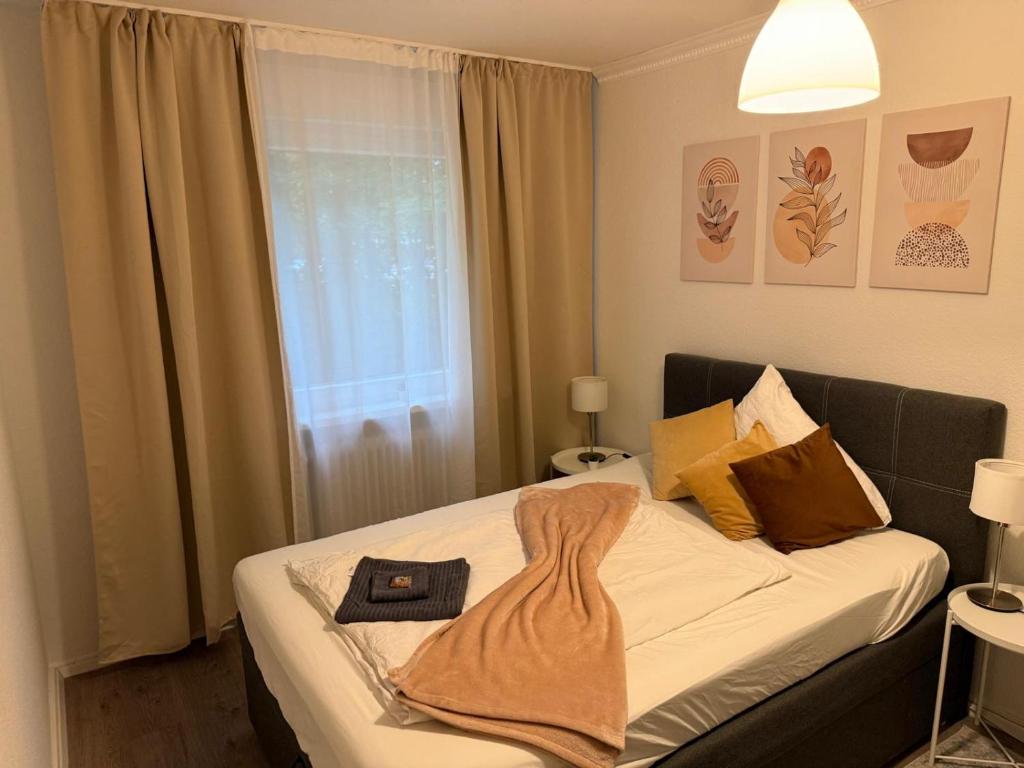 a bedroom with a bed with a robe on it at Schönes Apartment in Top-Lage Karlsruhe in Karlsruhe