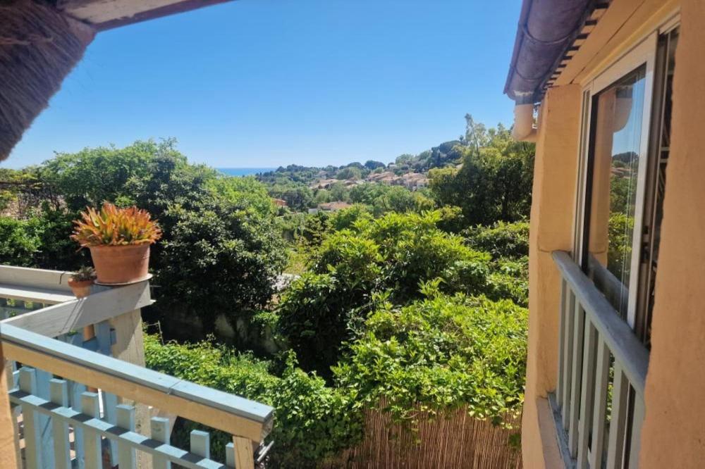 a balcony with a view of a forest of trees at Maison Diana in Vence
