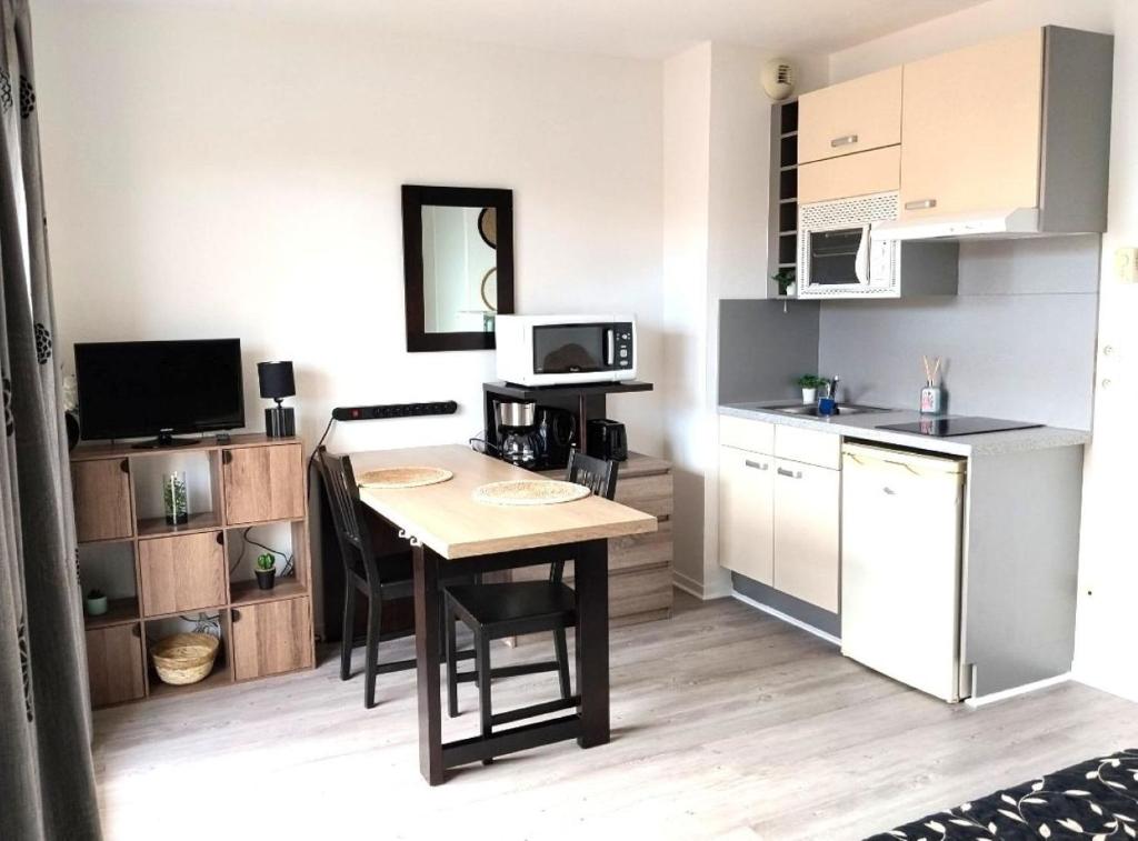 a small kitchen with a table in a room at Virginia N 203 ST2 in Grasse