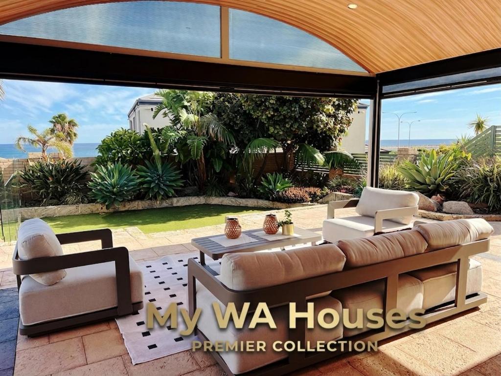 a living room with a couch and chairs on a patio at Ocean View Sunset Resort in Perth