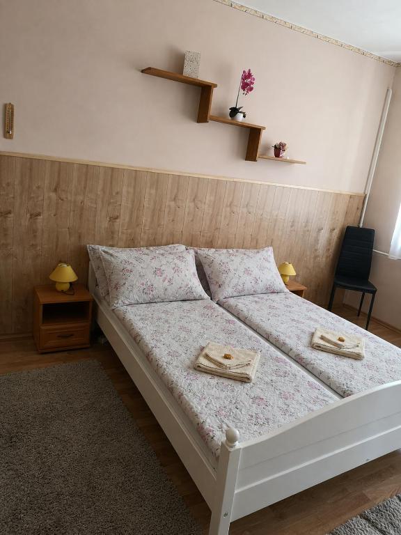 a bedroom with a bed with two plates on it at Natasa Apartman in Orosháza