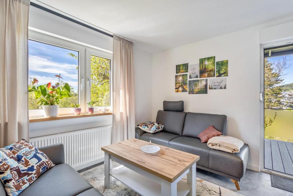 a living room with a couch and a table at Apartment Burgquartier in Schmallenberg