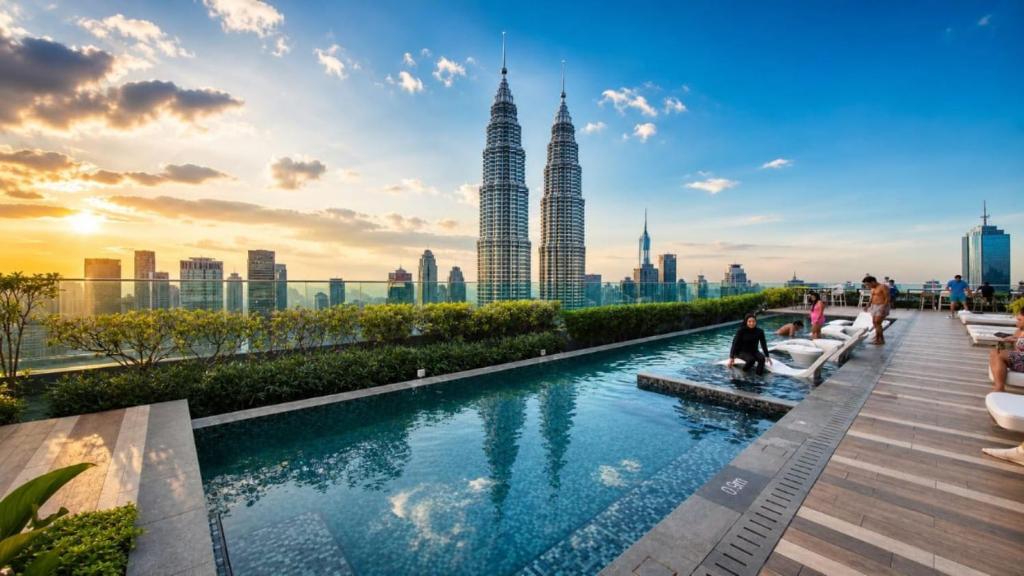 a pool on the roof of a building with a city skyline at STAR Residence KLCC - Dreamland Holiday Home in Kuala Lumpur