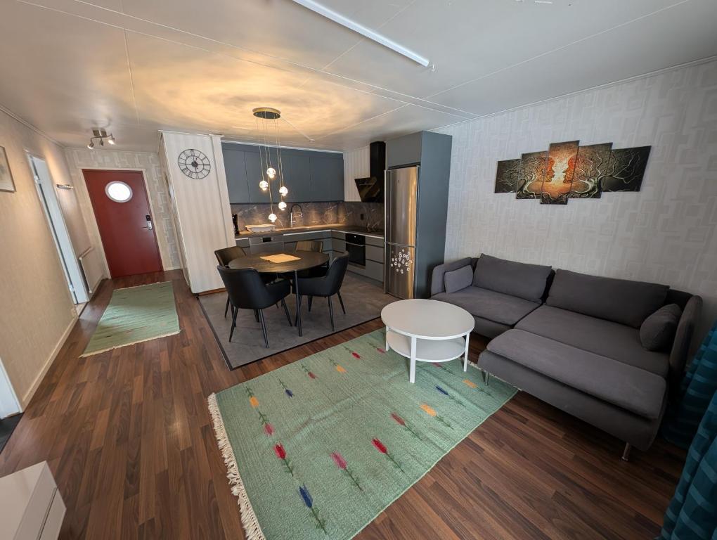 a living room with a couch and a table at Villa Vilsam in Gällivare