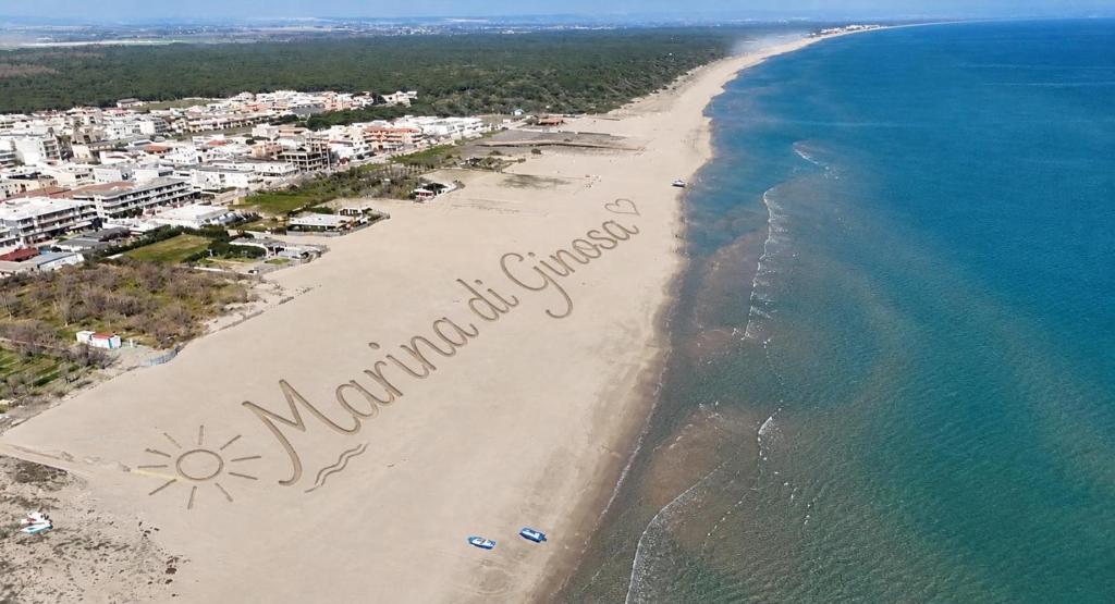 a sign on a beach with the words welcome to maho beach at Villa OLGA in Ginosa Marina