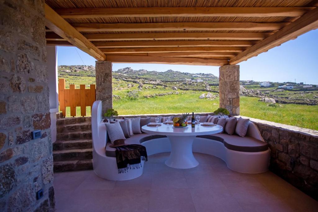 a patio with a table and chairs and a view at Mystic Horizon in Mikonos