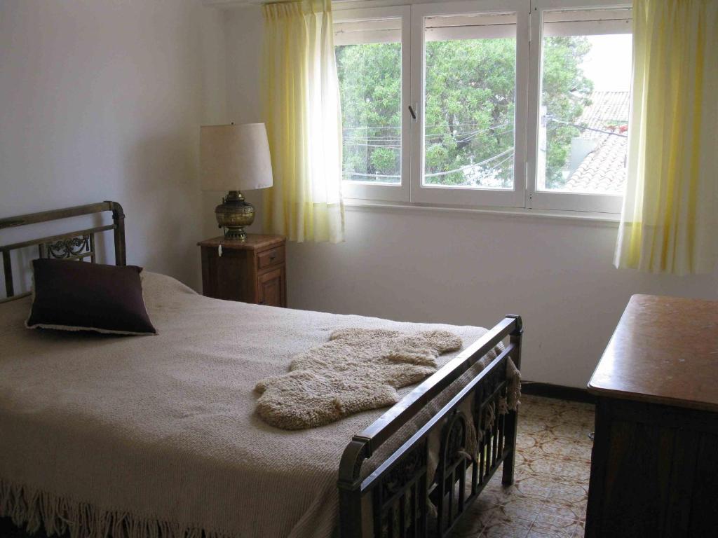 a bedroom with a bed and a window at Seaside Miramar Apartment in Miramar