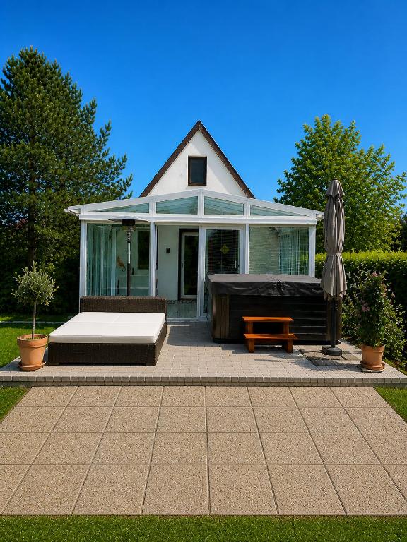 a house with a large bed and a patio at DIÓFA APARTMAN in Pilismarót