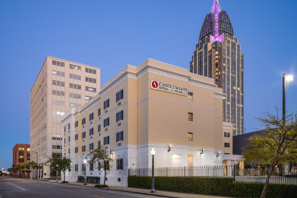 a building with a sign on the side of it with buildings at Candlewood Suites Mobile-Downtown by IHG in Mobile