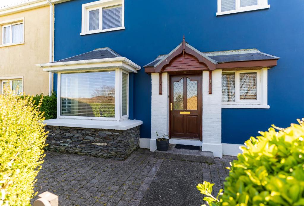 a blue house with a door and a window at Mariner's Rest - Cahersiveen in Cahersiveen
