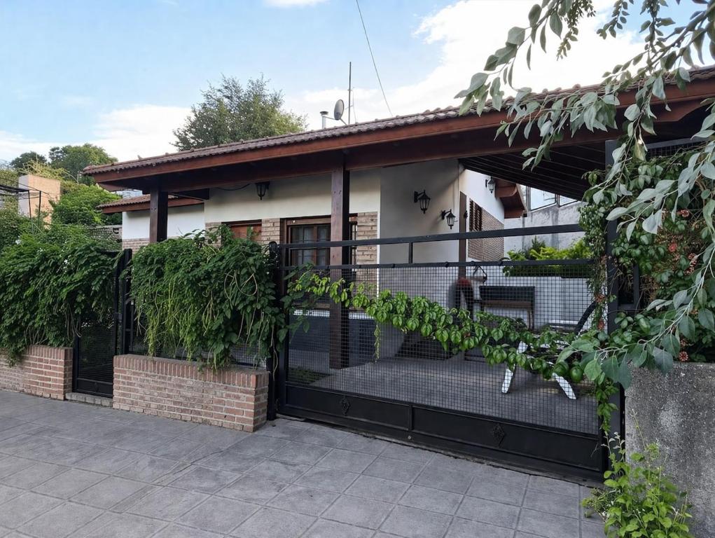 a house with a gate in front of it at Comfortable house in La Falda in La Falda