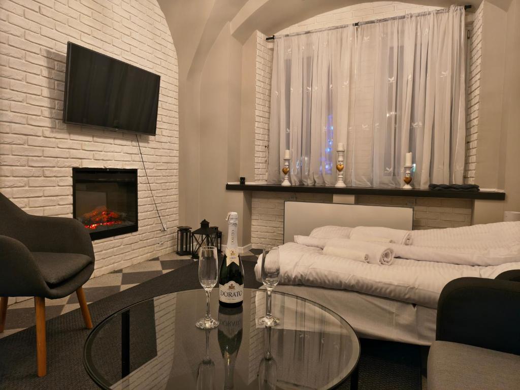 a living room with a couch and a fireplace at Apartament Florian Rynek 3 in Radków
