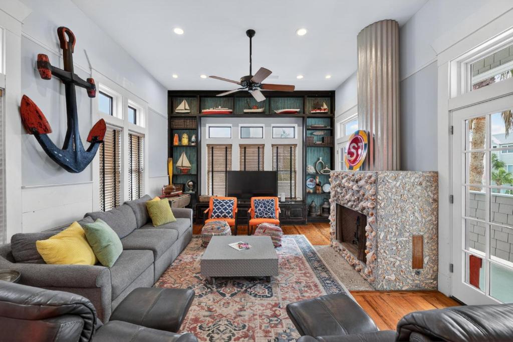 a living room with a couch and a fireplace at Emil Cottage in Saint Simons Island