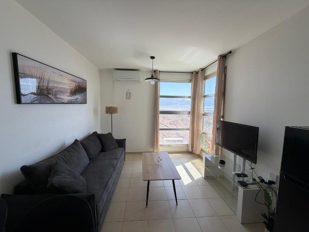 a living room with a couch and a table at Room 805 in Eilat