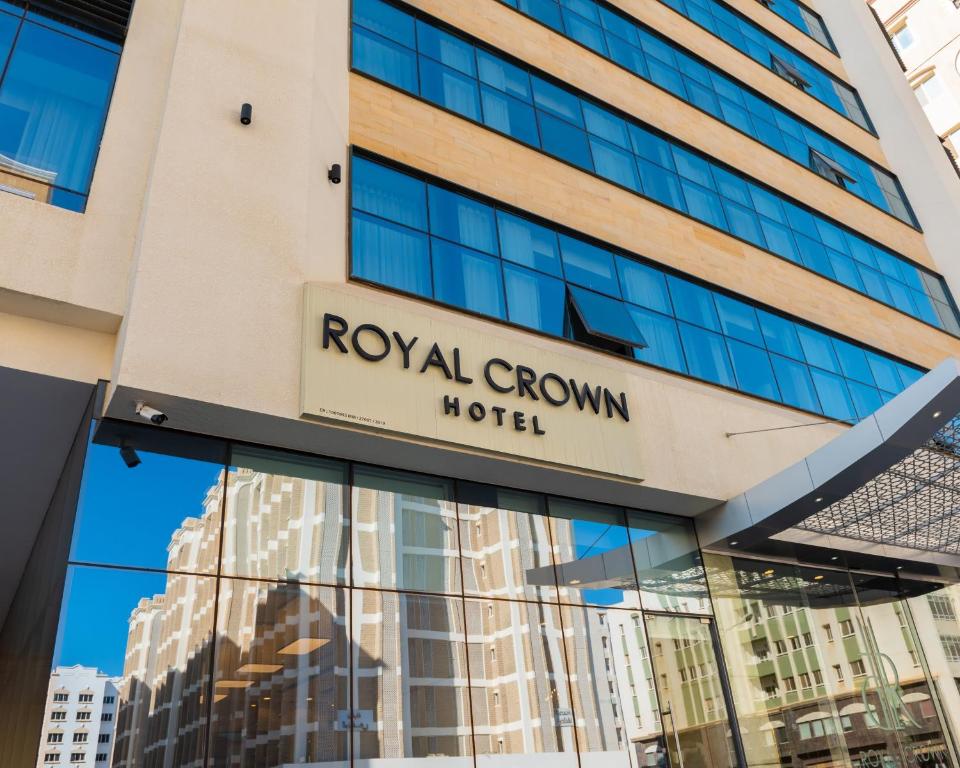 a building with a royal crown hotel sign on it at Royal Crown Muscat in Muscat