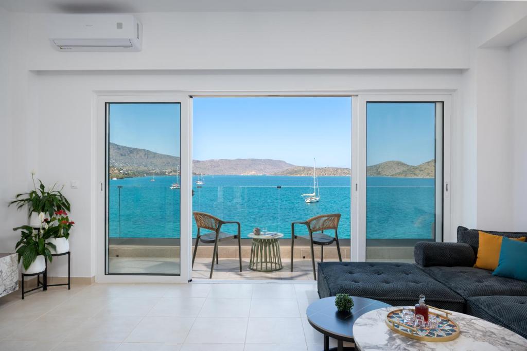a living room with a view of the ocean at Blue Horizon Elounda in Elounda