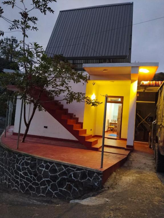 a small house with a staircase in front of it at Ella Top Sky in Bandarawela