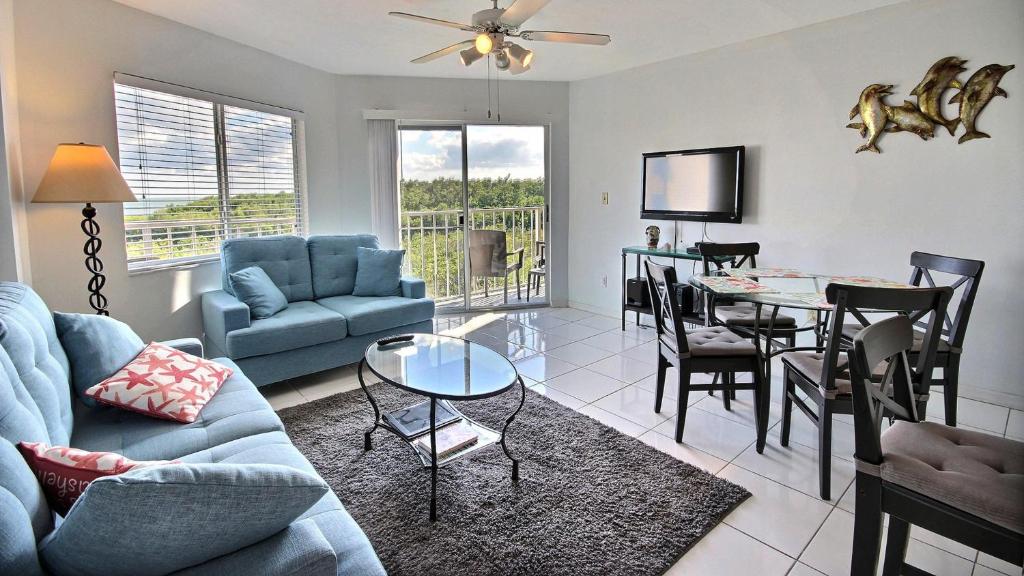 a living room with a blue couch and a table at 2306 Ocean Pointe Suites in Tavernier