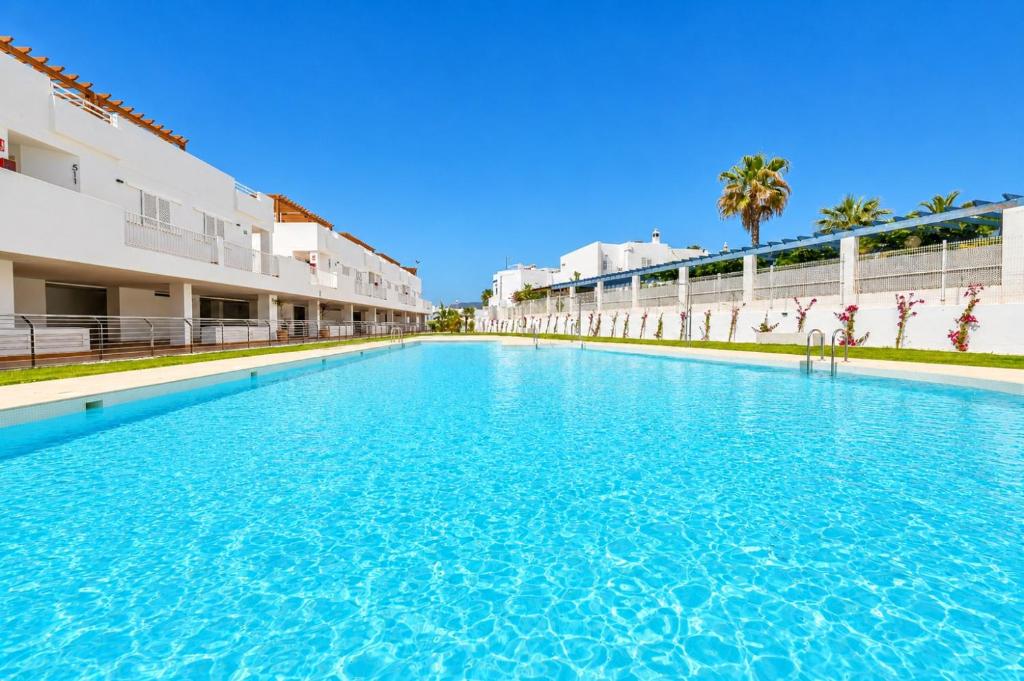 a large swimming pool in front of a building at AlmeriaSuite Mojacar Breeze Apartments in Mojácar