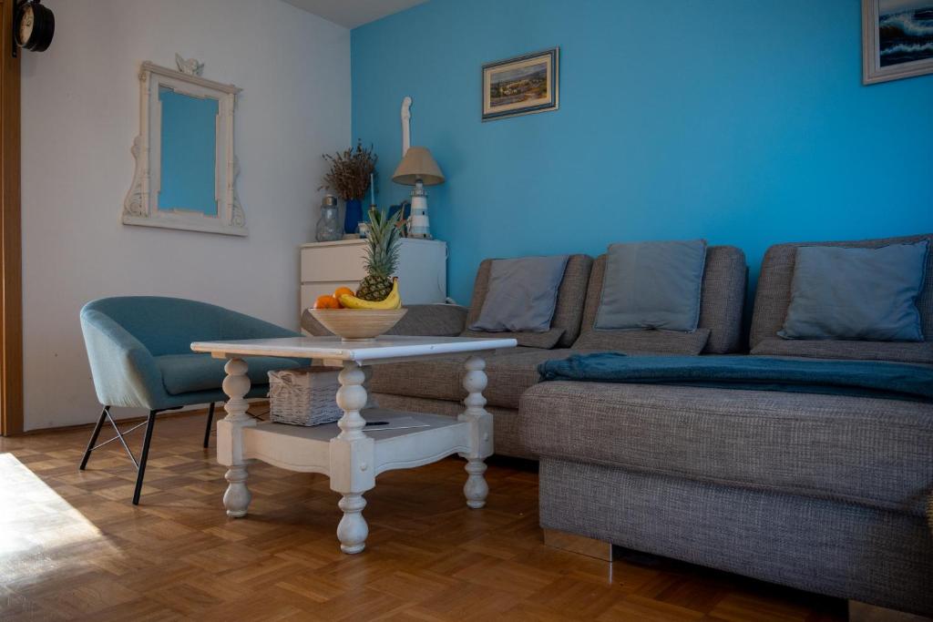 a living room with a couch and a table at Apartman Jedro in Vukovar