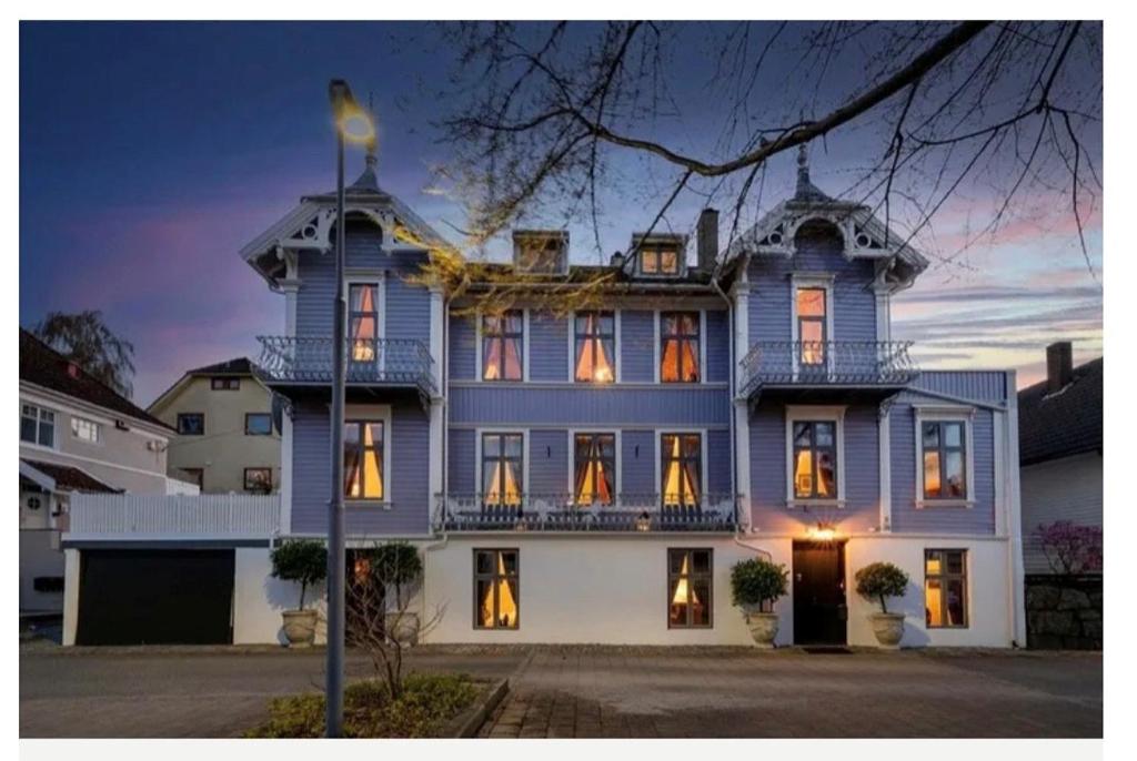 a large blue and white house with a balcony at Villa Eckhoff in Stavanger