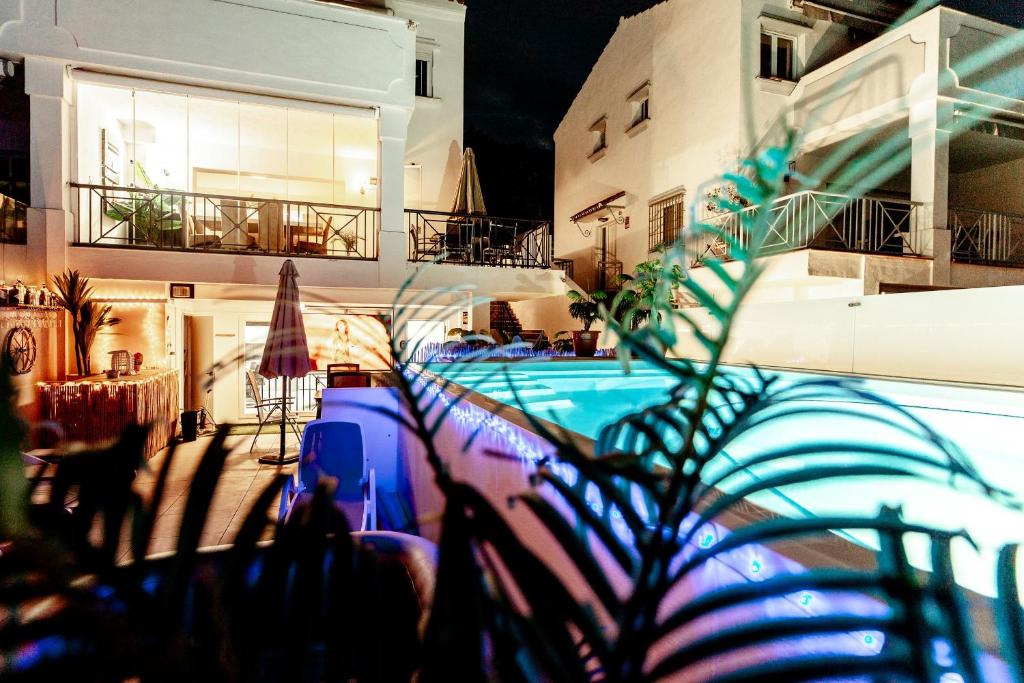 a swimming pool in front of a house at night at Unique Villa Scandinavia Marbella in Marbella