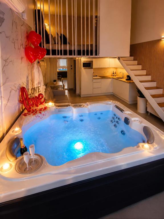 a jacuzzi tub in the middle of a room at Villa Bono Romantic Suite & Private Jacuzzi in Saint-Laurent-du-Var