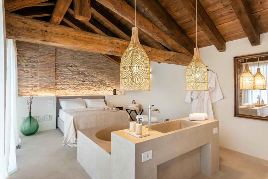 a bedroom with a bed and a sink in a room at Suite della Torre in Cavernago
