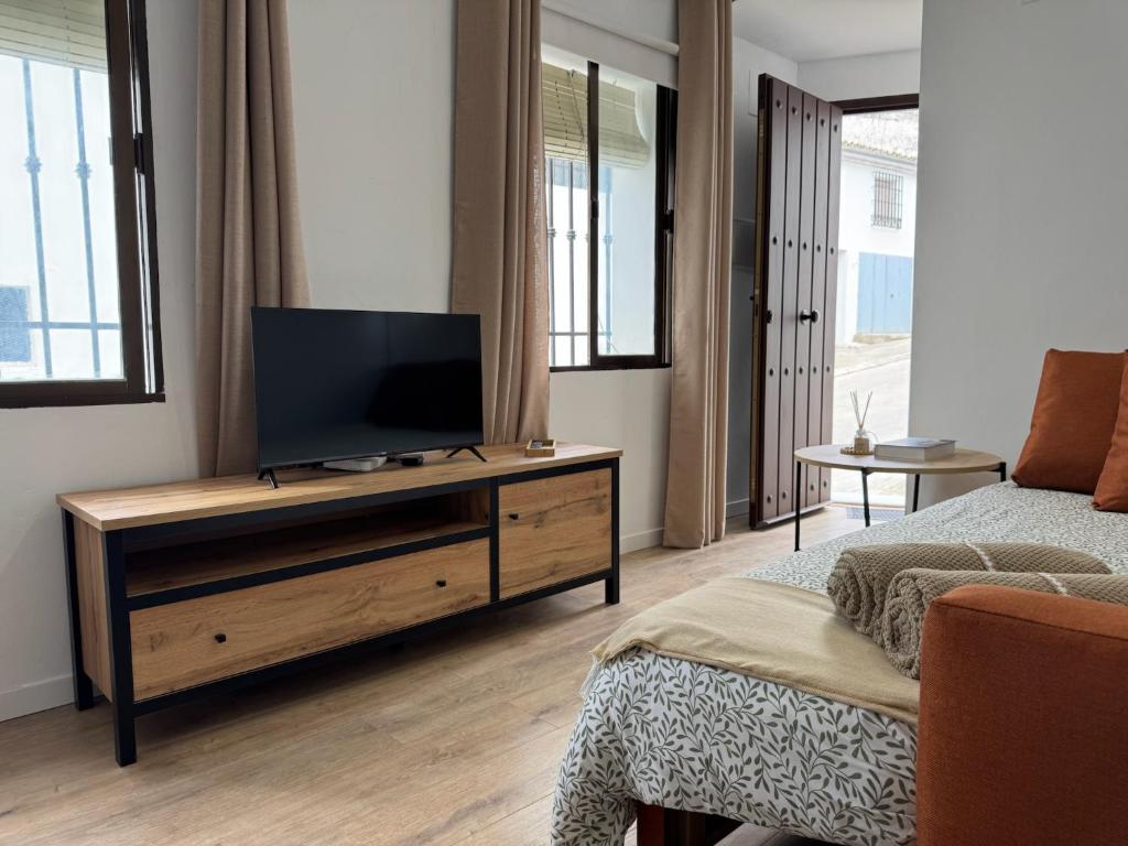 a living room with a flat screen tv on a wooden dresser at LaJoya Zuheros Suite in Zuheros