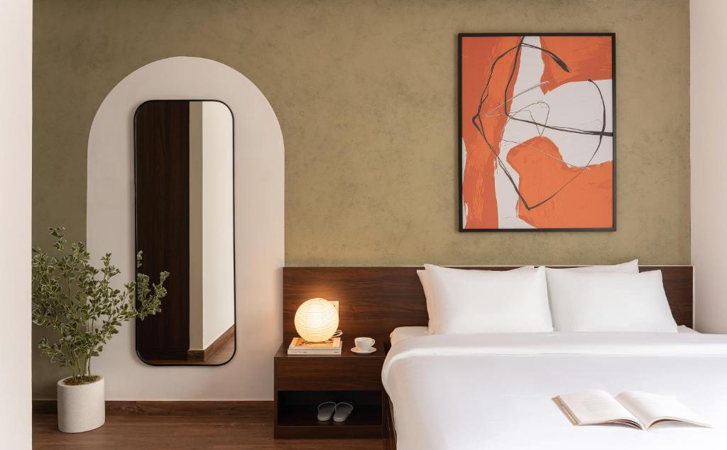 a bedroom with a bed and a large mirror at V Living - Downtown Saigon Stay with Free Laundry in Ho Chi Minh City