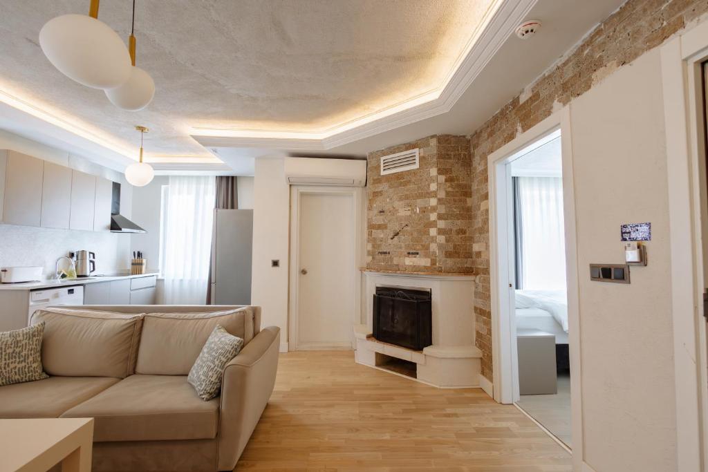 a living room with a couch and a fireplace at Arya Pansiyon Konyaaltı in Antalya