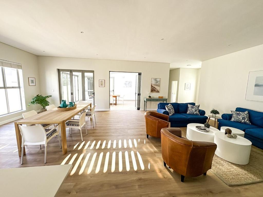 a living room with a blue couch and a table at Bluebay Villa in Britannia Bay