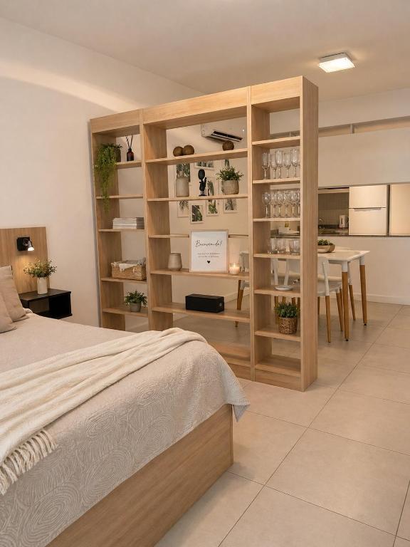 a bedroom with a bed and a dining room at Lezama Park in Buenos Aires
