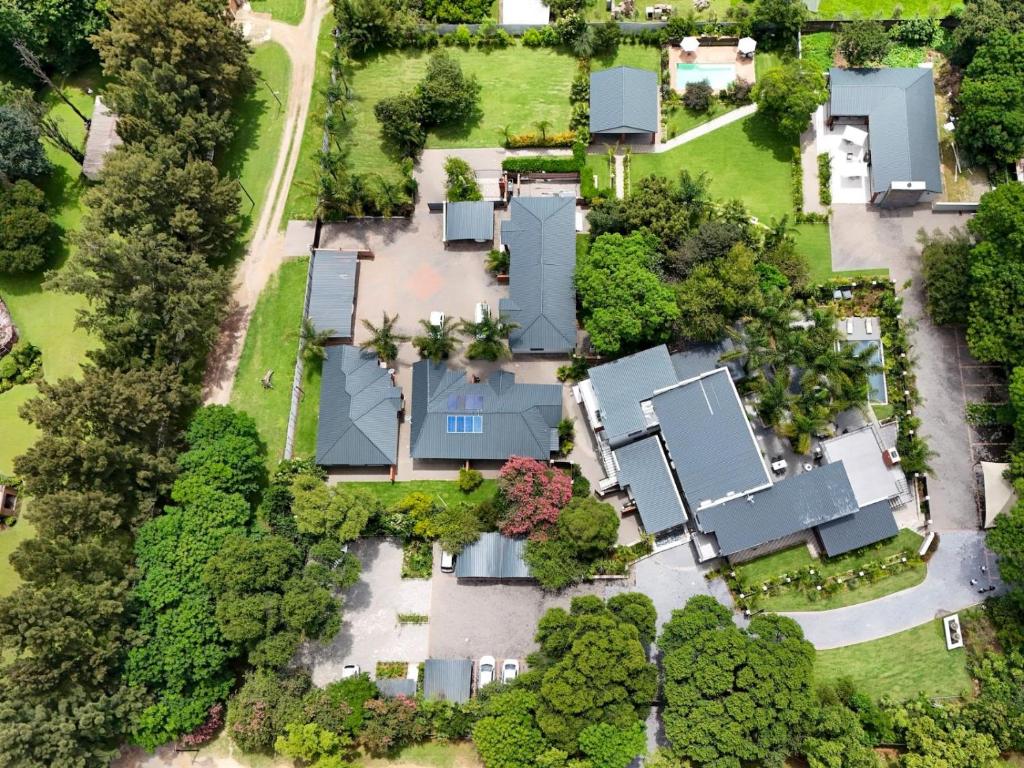 an overhead view of a house with trees and houses at Pitzer Suites in Midrand