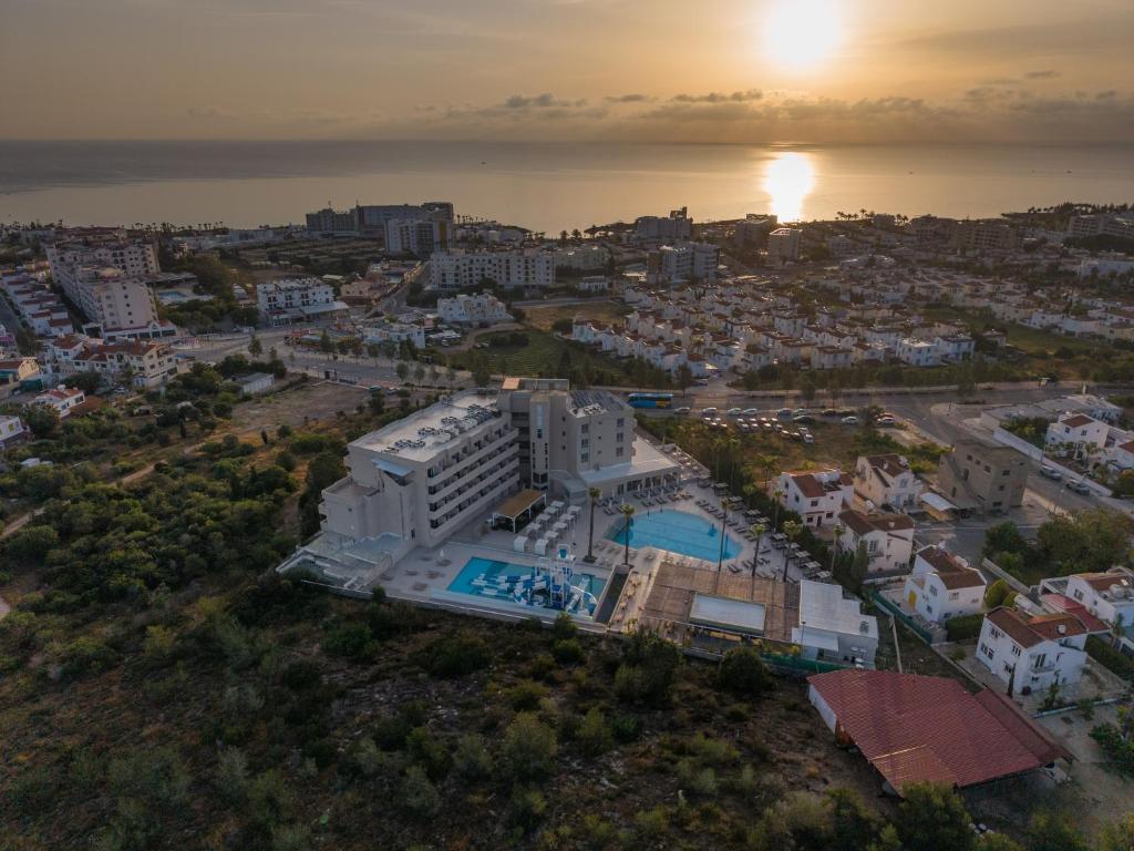 an aerial view of a city with the ocean at Toxotis Hotel in Protaras