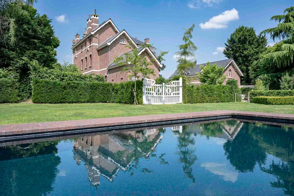 ein Haus mit einem Swimmingpool vor dem Haus in der Unterkunft Villa Copis in Borgloon