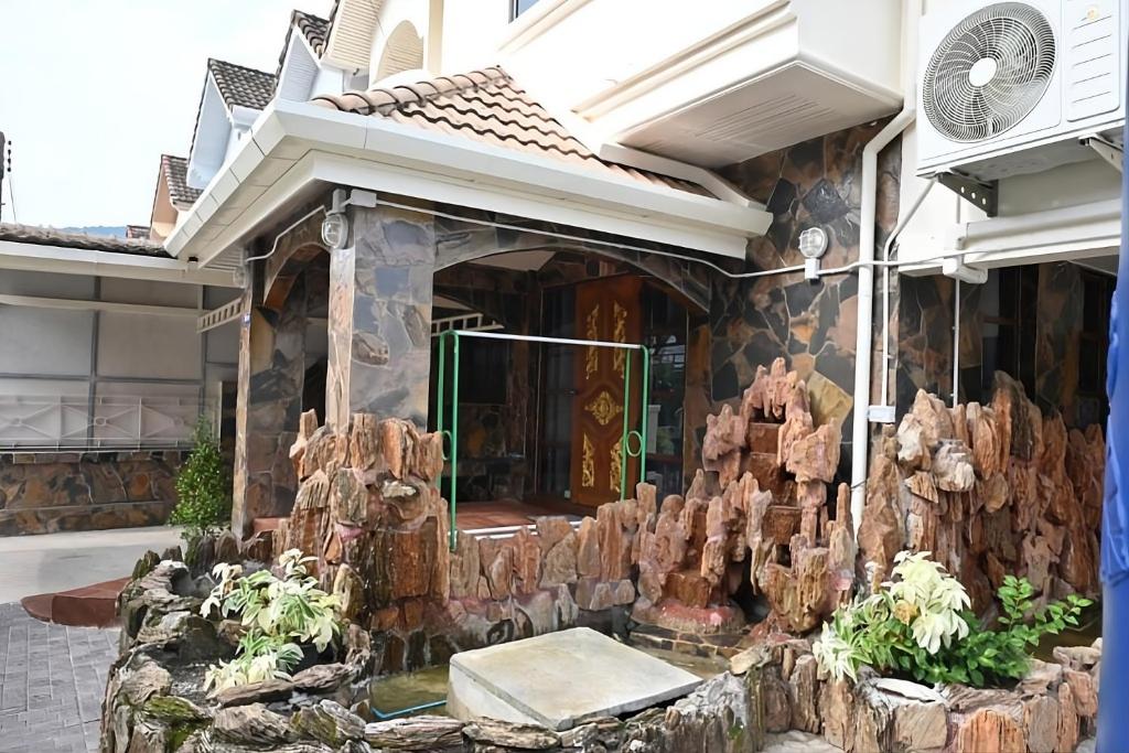 a house with a tree stump on the front of it at Patong Beach private Villa in Patong Beach