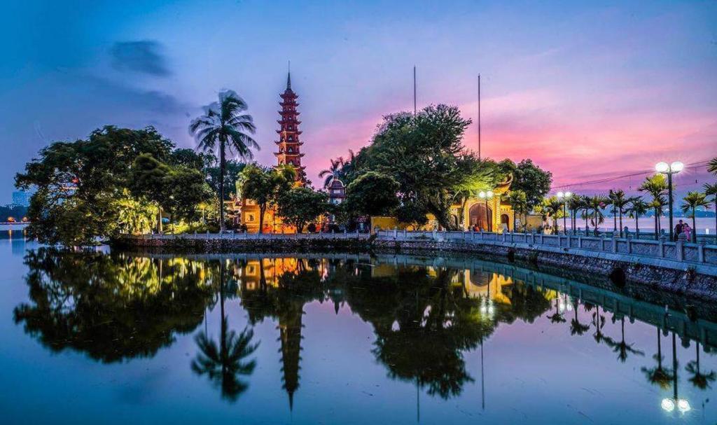 a view of a river with a tower in the background at Van Hoa Boutique Hotel in Hanoi