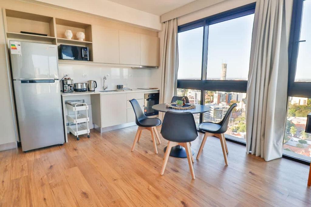 a kitchen with a table and chairs in a room at Just 100 meters from Shopping del Sol in Asunción