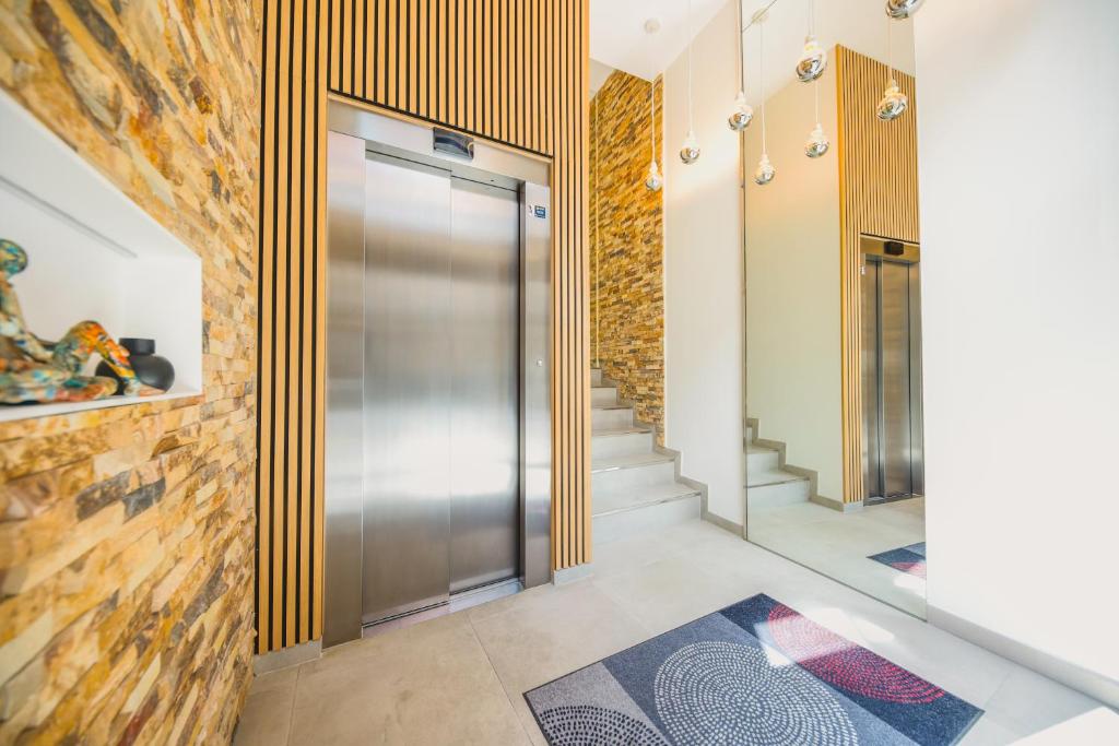 a hallway with a metal door in a building at Villa Artista home in Pontevedra