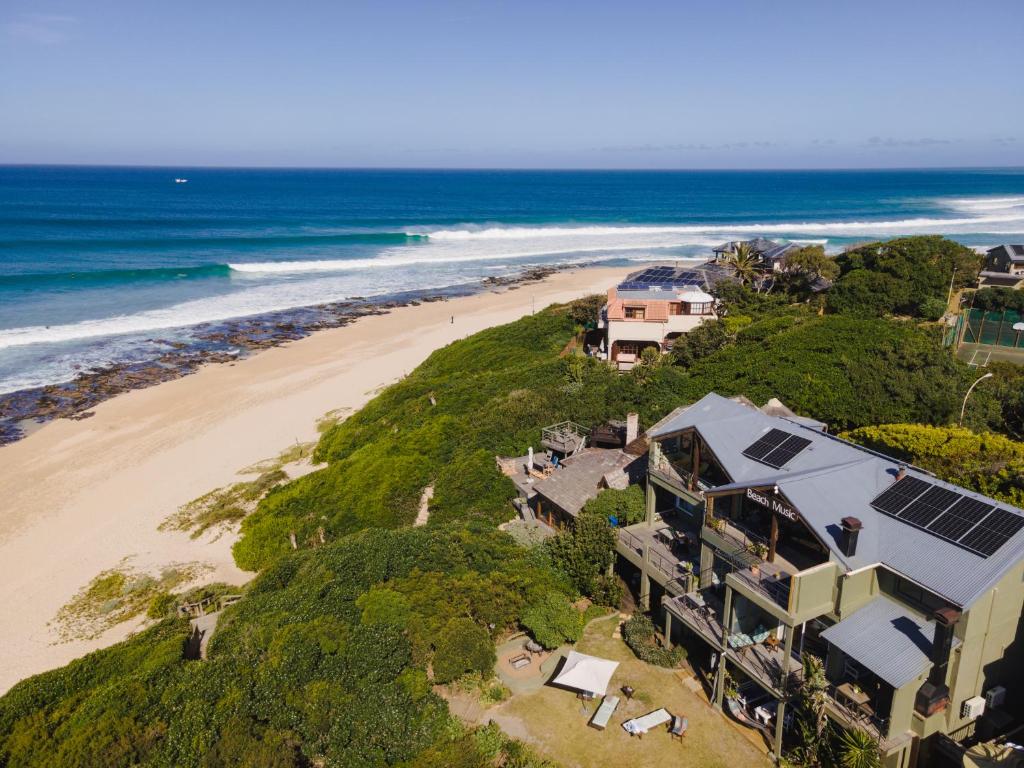 an aerial view of a house and the beach at Beach Music in Jeffreys Bay