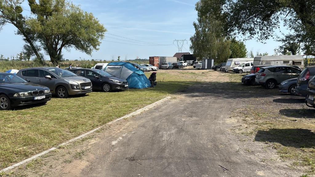 a bunch of cars parked in a parking lot at Przystań Lubikowo in Lubikowo