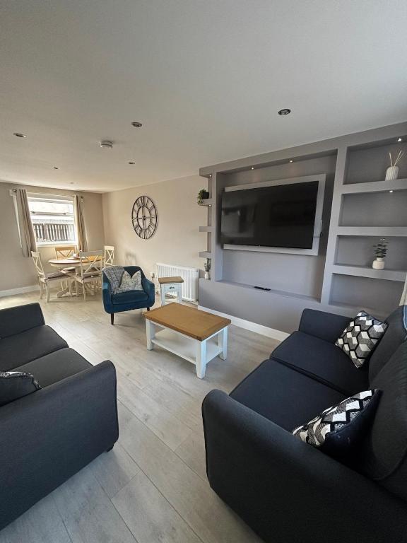 a living room with two couches and a tv at Caol Mountain View in Caol