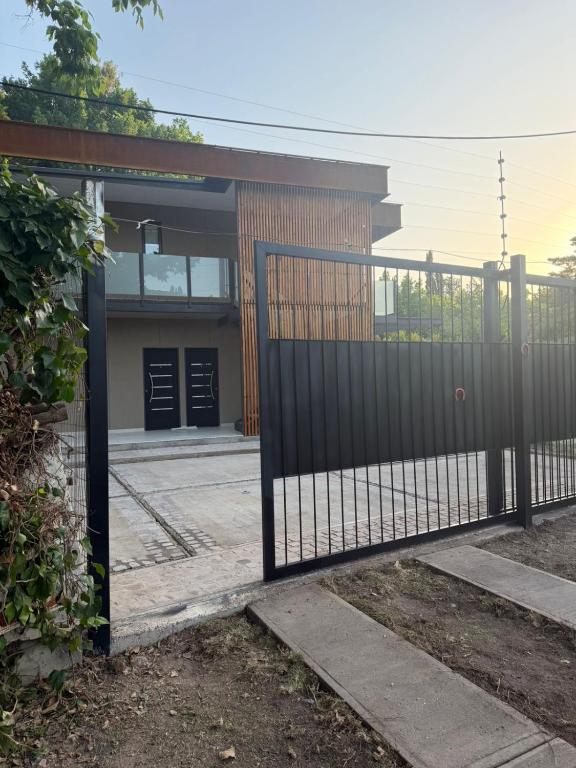 a metal gate in front of a building at Terracampo Apart in Ciudad Lujan de Cuyo
